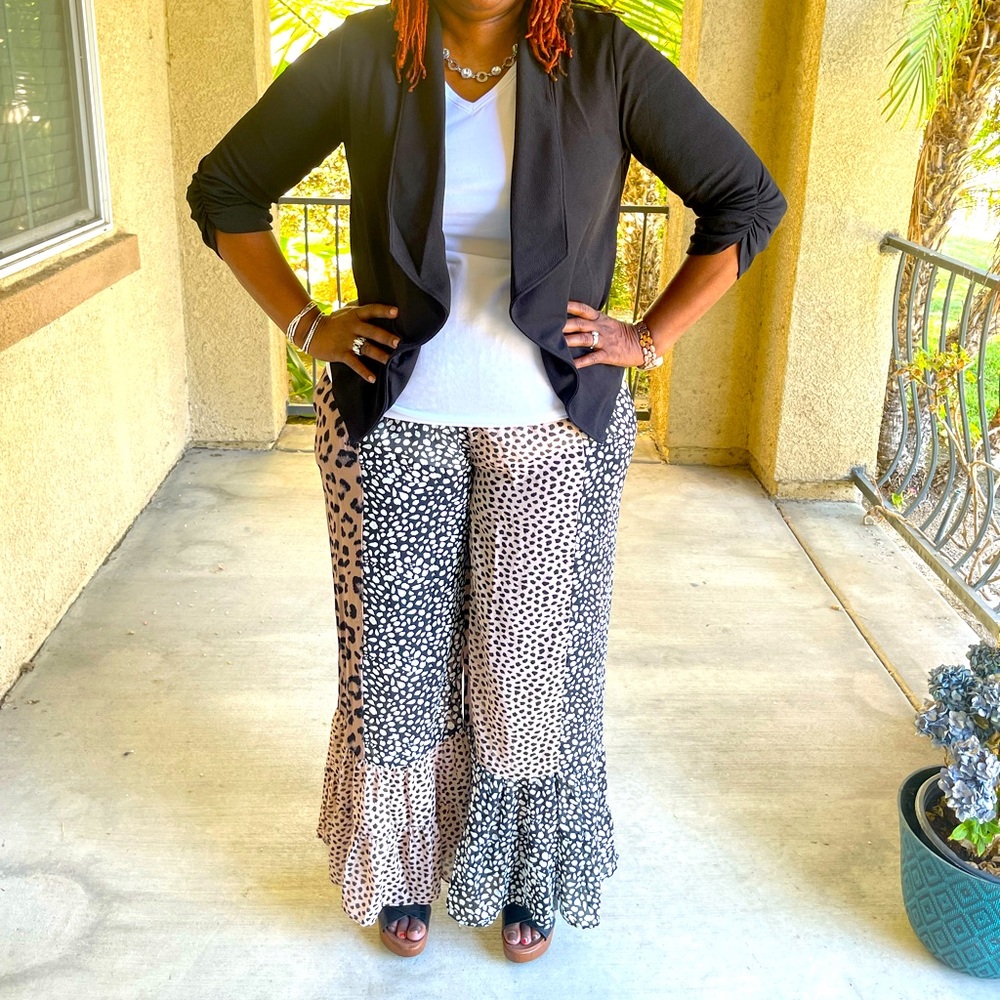 Black jacket. Animal print wide leg pants. Black shirt.